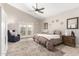 This bedroom features a ceiling fan, private access to the backyard, and a neutral color scheme at 3765 E Del Rio St, Gilbert, AZ 85295