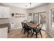 Cozy dining area features a wood table, black chairs, and sliding door access to the backyard at 3765 E Del Rio St, Gilbert, AZ 85295