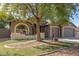Charming home exterior with mature tree, arched window, and three-car garage at 3765 E Del Rio St, Gilbert, AZ 85295