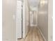 Hallway features wood floors, neutral walls, and white doors with silver hardware at 3765 E Del Rio St, Gilbert, AZ 85295