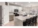 Spacious kitchen boasts a center island with seating, white cabinets, and modern appliances at 3765 E Del Rio St, Gilbert, AZ 85295