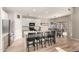 Bright kitchen with island seating flows into a dining area with backyard access and contemporary light fixture at 3765 E Del Rio St, Gilbert, AZ 85295