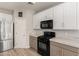 Close up on kitchen with white cabinets, marble counter tops, and a black gas range at 3765 E Del Rio St, Gilbert, AZ 85295