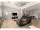 Comfortable living room with tile floors, a contemporary ceiling fan, and modern decor at 3765 E Del Rio St, Gilbert, AZ 85295