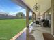 Inviting covered patio with comfortable seating, stylish lighting, and a view of the expansive backyard at 3765 E Del Rio St, Gilbert, AZ 85295