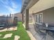 Covered patio with an outdoor dining area, a hot tub, and lush green grass at 3765 E Del Rio St, Gilbert, AZ 85295