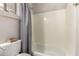 Bathroom shower displays neutral tones, white tub and shower, and a window for natural light at 3765 E Del Rio St, Gilbert, AZ 85295