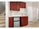 Wet bar features wood cabinets, mini fridge, white countertop, and neutral walls at 3765 E Del Rio St, Gilbert, AZ 85295