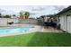 Backyard featuring a pool, patio furniture, and artificial turf at 4026 W Saint John Rd, Glendale, AZ 85308