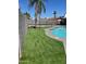 Backyard with artificial turf surrounding a pool, and a black fence at 4026 W Saint John Rd, Glendale, AZ 85308