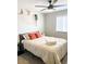 Comfortable bedroom features a large bed, decorative pillows, and a modern ceiling fan at 4026 W Saint John Rd, Glendale, AZ 85308