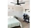 Bedroom with a desk and ceiling fan, light green bedspread and natural lighting at 4026 W Saint John Rd, Glendale, AZ 85308