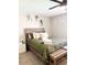 Cozy bedroom featuring a wood accent wall, decorative pillows, and light-colored walls at 4026 W Saint John Rd, Glendale, AZ 85308