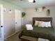 Cozy bedroom featuring stylish decor, a wooden headboard, and patterned bedding at 4026 W Saint John Rd, Glendale, AZ 85308