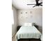 Bedroom featuring a bed, side tables and bright light from a window and modern ceiling fan at 4026 W Saint John Rd, Glendale, AZ 85308