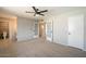 Open bedroom with a tiled bathroom, and white doors at 4026 W Saint John Rd, Glendale, AZ 85308