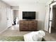 Comfortable bedroom with a large dresser, a TV, and a view of the bathroom at 4026 W Saint John Rd, Glendale, AZ 85308