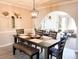 Dining room features a modern light fixture and an arched entrance to the living room at 4026 W Saint John Rd, Glendale, AZ 85308
