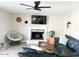 Comfortable living room with a fireplace and a large television for entertainment at 4026 W Saint John Rd, Glendale, AZ 85308