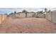 A large low maintenance backyard features gravel landscaping, block fencing and perimeter access at 406 E Saguaro St, Casa Grande, AZ 85122