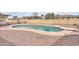 A beautiful backyard pool featuring updated concrete, coping, and a diving board at 406 E Saguaro St, Casa Grande, AZ 85122