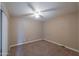 A standard bedroom with carpet floors, neutral walls and ceiling fan at 406 E Saguaro St, Casa Grande, AZ 85122