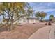 Street view of a single-story home featuring a two car garage and low maintenance rock landscaping at 406 E Saguaro St, Casa Grande, AZ 85122