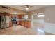 Open kitchen with stainless steel appliances, granite countertops, and tile flooring at 406 E Saguaro St, Casa Grande, AZ 85122