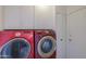 Laundry room featuring a red Samsung washer and dryer set and white cabinets at 406 E Saguaro St, Casa Grande, AZ 85122