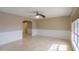 Spacious living room with tile flooring, decorative wainscoting and updated ceiling fan at 406 E Saguaro St, Casa Grande, AZ 85122