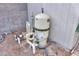 Image shows the pool equipment with sand filter and plumbing and gravel landscaping at 406 E Saguaro St, Casa Grande, AZ 85122