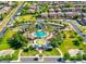 Aerial view of community pool and amenities surrounded by well-manicured landscaping and residential homes at 44560 W Copper Trl, Maricopa, AZ 85139