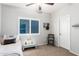 Bedroom featuring a queen-size bed, bedside table and a plush decorative chair at 44560 W Copper Trl, Maricopa, AZ 85139