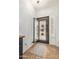 Inviting foyer featuring tile flooring, a secure iron door, and natural light from the shutters at 44560 W Copper Trl, Maricopa, AZ 85139