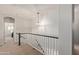 Upstairs hallway with views into bedrooms and staircase at 44560 W Copper Trl, Maricopa, AZ 85139