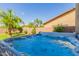 Inviting backyard hot tub perfect for relaxation, surrounded by lush landscaping for added privacy at 44560 W Copper Trl, Maricopa, AZ 85139