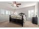 Bedroom features a ceiling fan and large window that provides natural lighting at 44560 W Copper Trl, Maricopa, AZ 85139