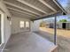 Covered back patio offering a shaded outdoor space, accessible from the interior with an open view to the fenced backyard at 470 S Daley --, Mesa, AZ 85204