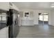 Bright kitchen features stainless steel refrigerator, light gray cabinetry, and updated countertops at 470 S Daley --, Mesa, AZ 85204