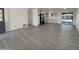 Open-concept living space showcasing modern vinyl flooring, a bright interior, and seamless flow to the kitchen and backyard at 470 S Daley --, Mesa, AZ 85204