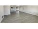 Spacious living area featuring modern vinyl floors, ample natural light, and easy access to the kitchen and outdoor patio at 470 S Daley --, Mesa, AZ 85204