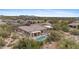 Expansive aerial view of a private desert home showcasing the sparkling pool, desert landscape, and neighborhood at 6128 E Brilliant Sky Dr, Scottsdale, AZ 85266