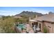 Inviting backyard featuring a sparkling pool, lounge chairs, desert landscaping, and views of the beautiful surrounding mountains at 6128 E Brilliant Sky Dr, Scottsdale, AZ 85266