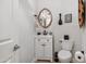 Powder room with a modern vanity, toilet, decorative mirror, and light neutral paint at 6128 E Brilliant Sky Dr, Scottsdale, AZ 85266