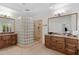 Dual sink bathroom with granite countertops and glass block shower at 6128 E Brilliant Sky Dr, Scottsdale, AZ 85266