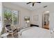 Bright bedroom with modern decor, light walls, and plantation shutters at 6128 E Brilliant Sky Dr, Scottsdale, AZ 85266