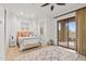 Bright bedroom with a sliding glass door to a patio and neutral-toned decor at 6128 E Brilliant Sky Dr, Scottsdale, AZ 85266