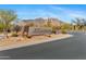 Welcoming entrance to the Golf and Country Club with desert landscaping and mountain views at 6128 E Brilliant Sky Dr, Scottsdale, AZ 85266