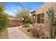 Beautiful home exterior with mature desert landscaping, stone walkway and neutral color scheme at 6128 E Brilliant Sky Dr, Scottsdale, AZ 85266
