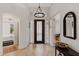 Home foyer with stone flooring, chandelier, mirror, and decor at 6128 E Brilliant Sky Dr, Scottsdale, AZ 85266